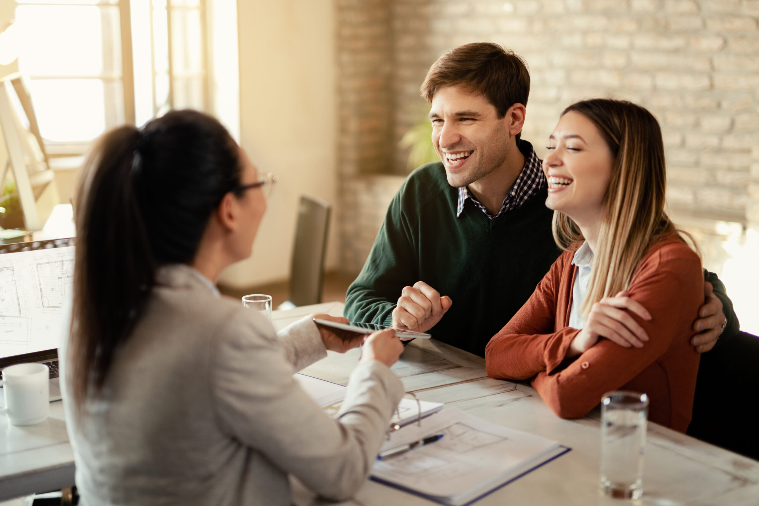 Young happy couple communicating with a Public Adjuster IZP Consulting